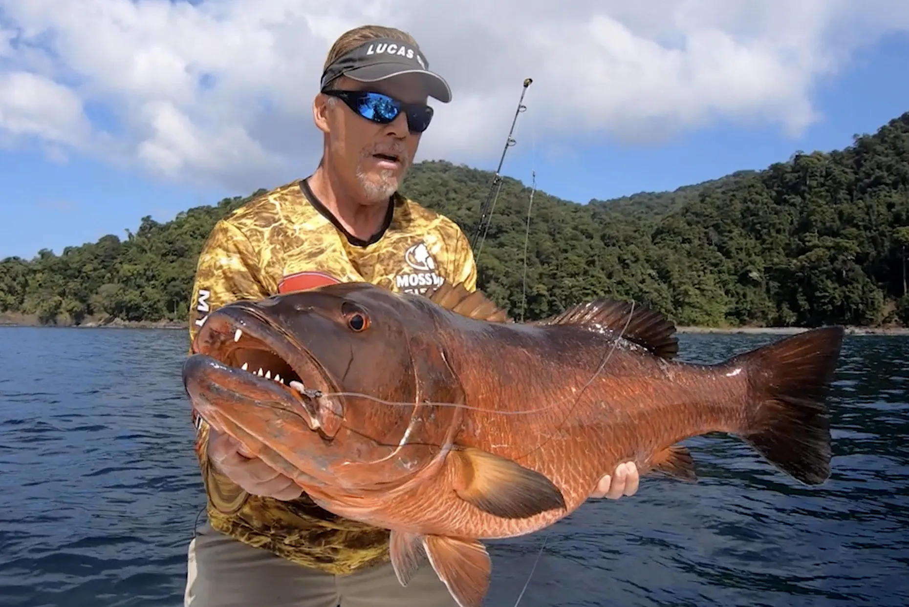 Mark Davis, un pêcheur, tient un gros poisson à dents.