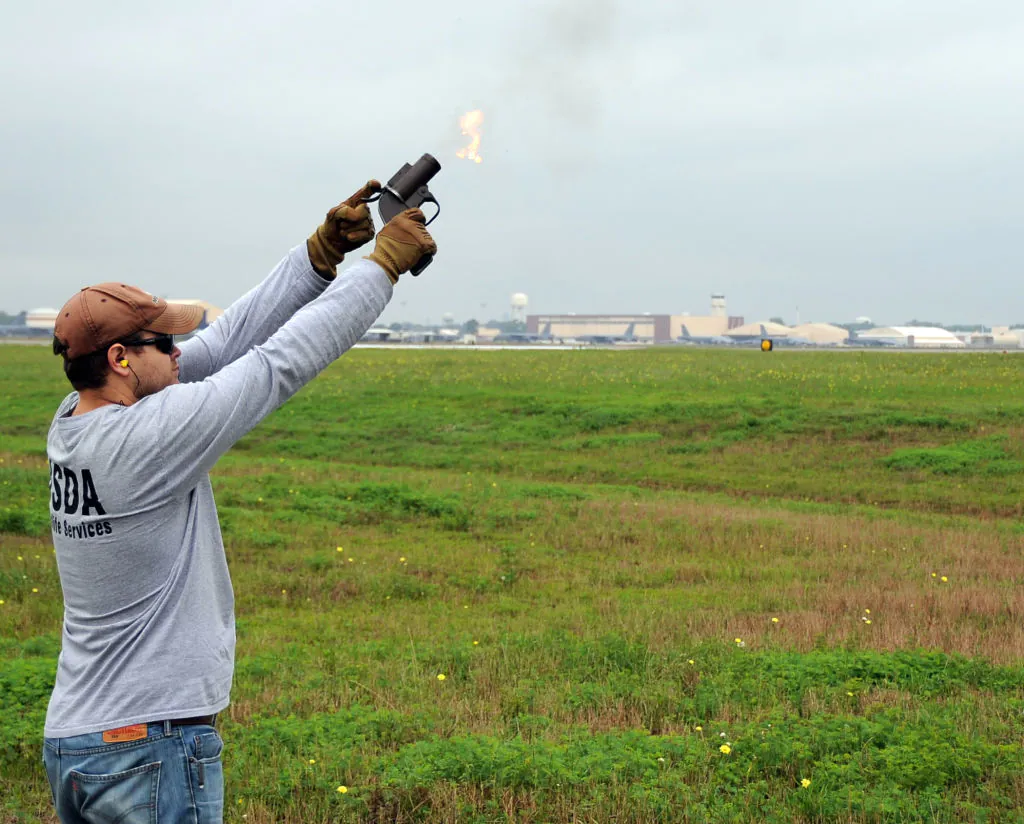 Un biologiste de la faune tire un pistolet de calibre 12 pour dissuader les oiseaux dans un aéroport