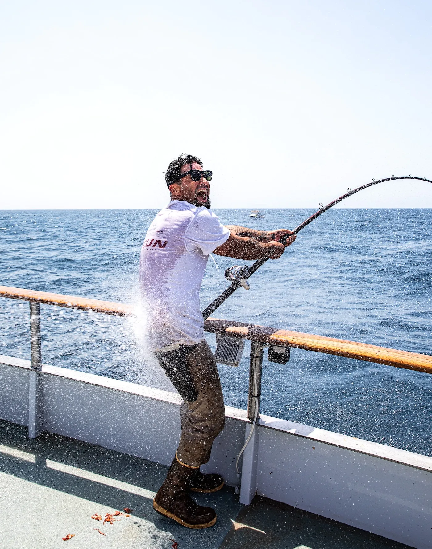 Un homme sourit alors qu'il se connecte à un poisson.