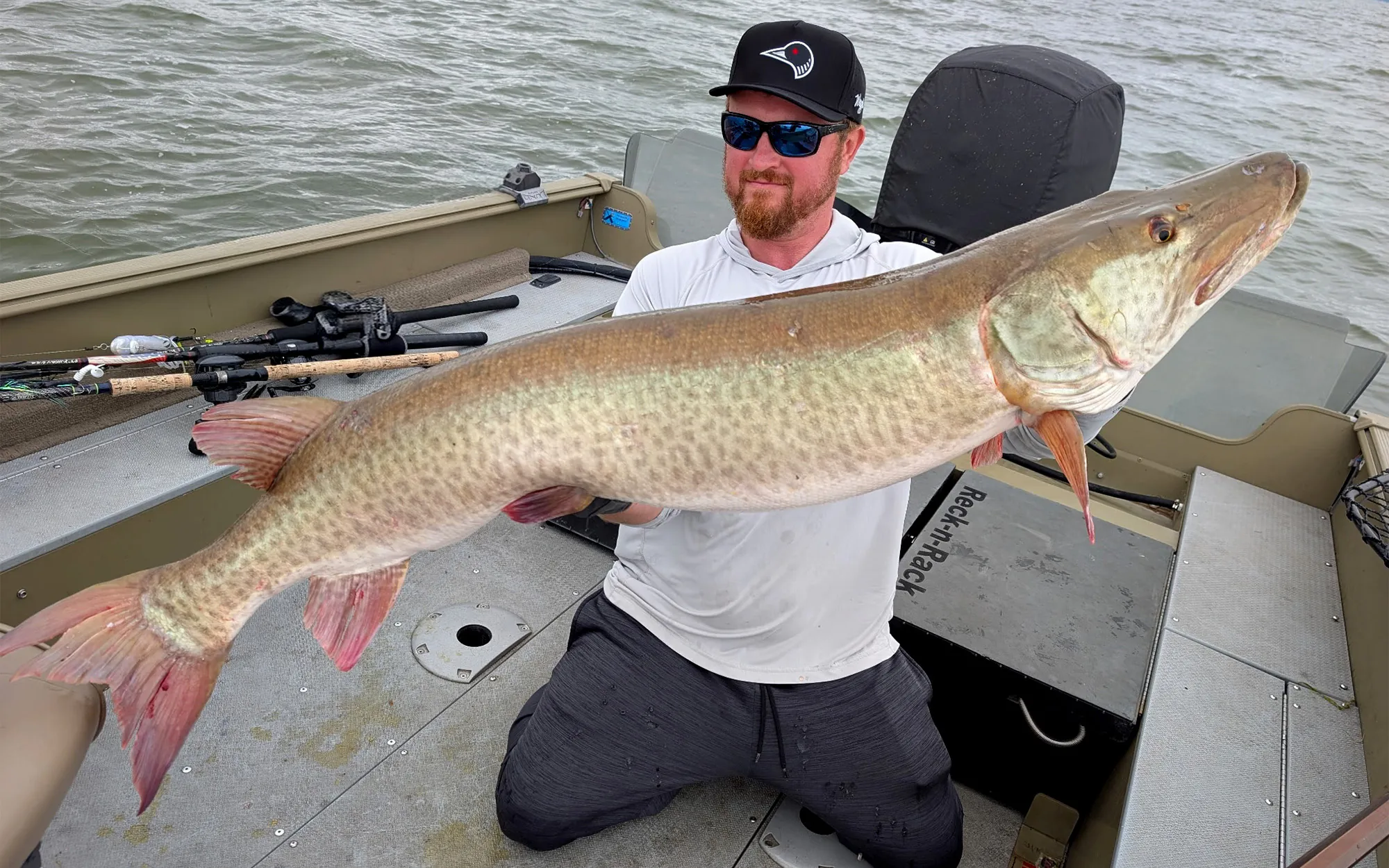 Un pêcheur tient un muskie géant de 56 pouces capturé dans le Wisconsin.