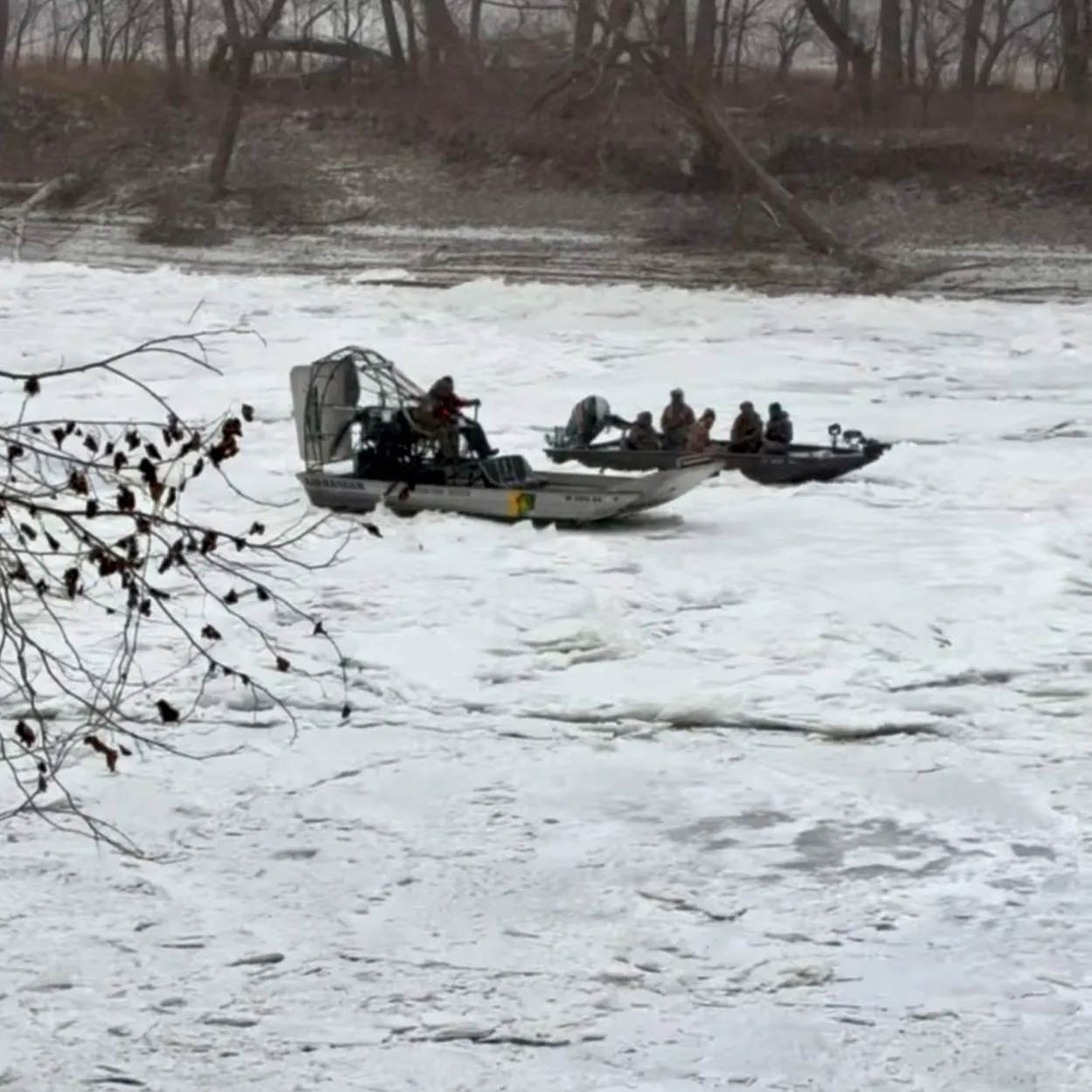 Un hydroglisseur sauvant un bateau-jonc d'une rivière gelée.