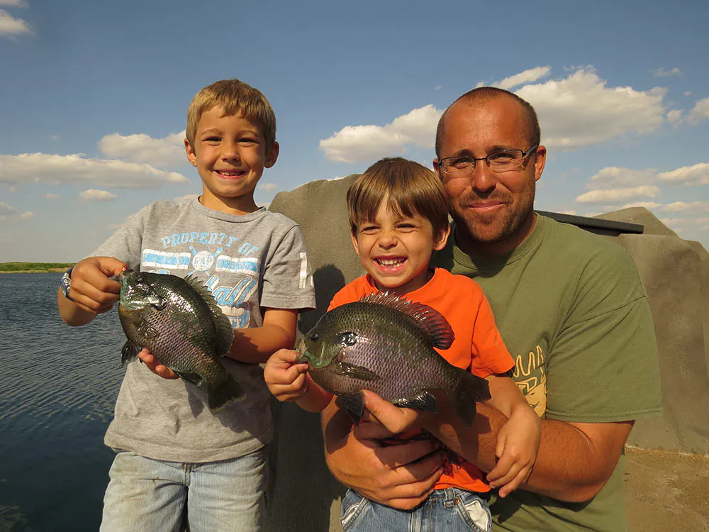 père et fils pêchant des crapets bleus